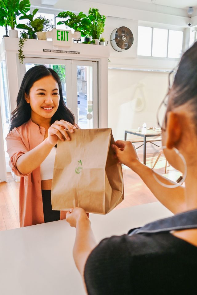 Customer getting to-go food at Avotoasty